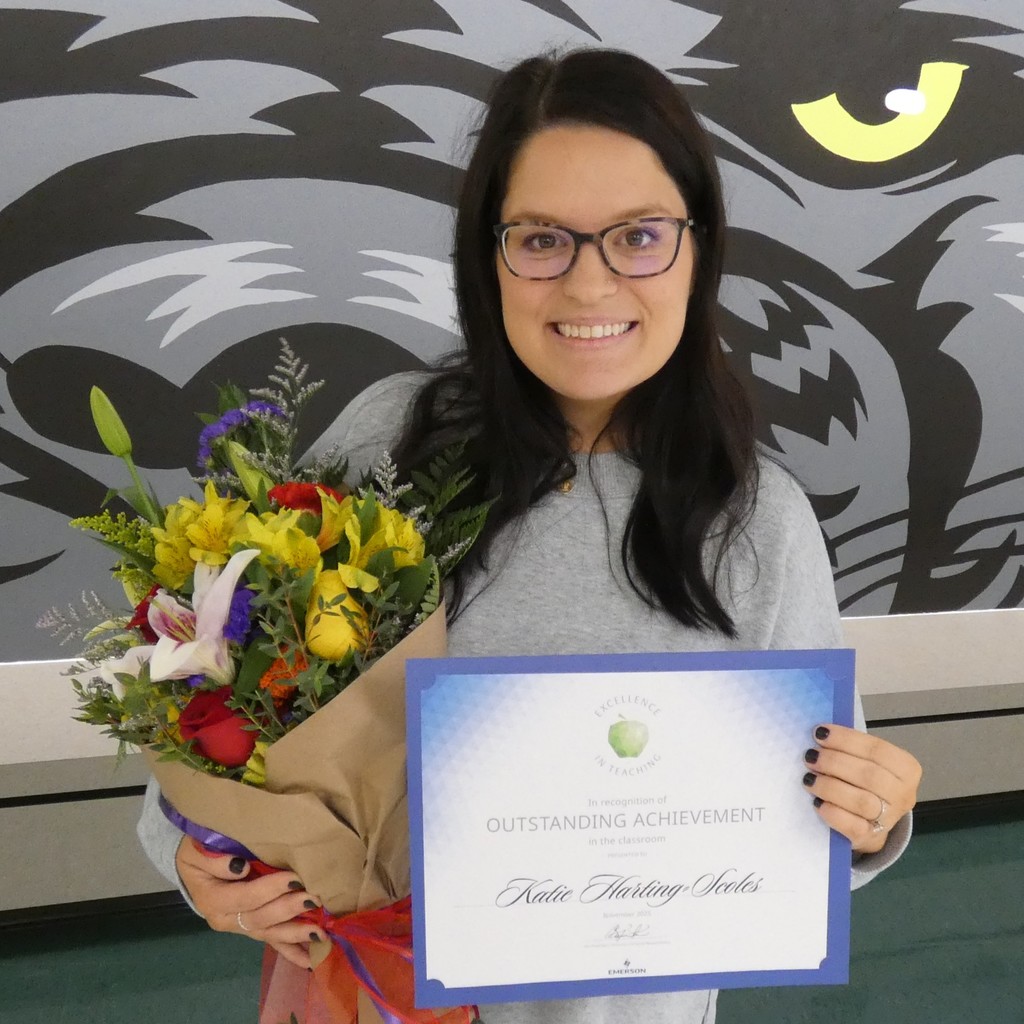 Harting Scoles poses with certificate and flowers