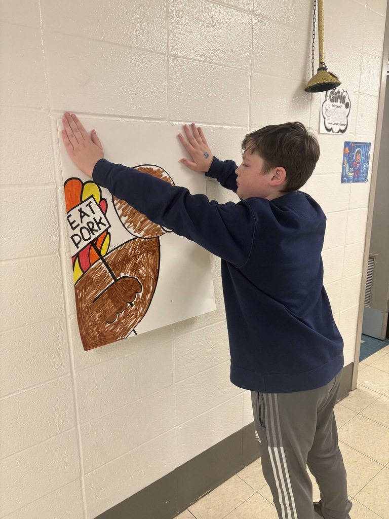 Archer hanging up his turkey poster