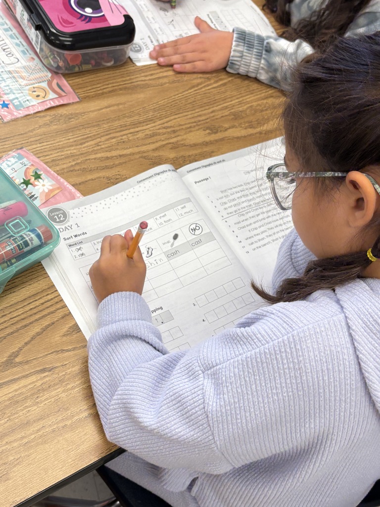 A 1st-grade student working on their "ch" and "sh" sounds in their workbook