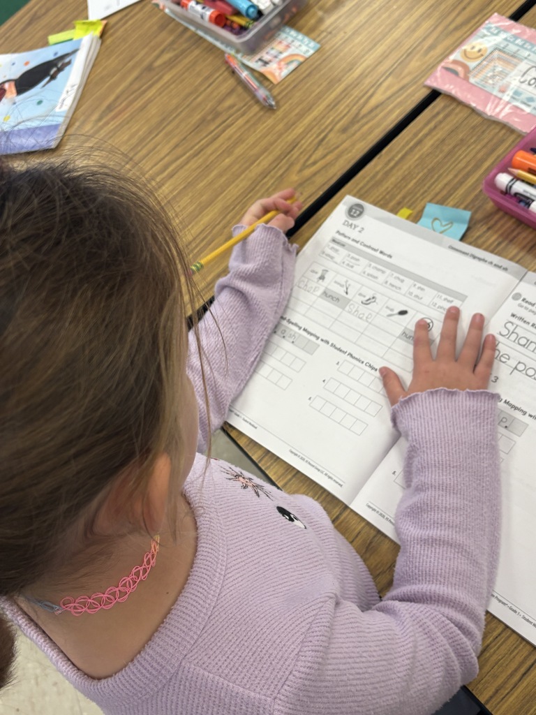 A 1st-grade student working on their "ch" and "sh" sounds in their workbook