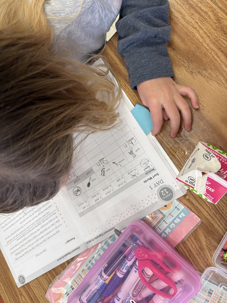 A 1st-grade student working on their "ch" and "sh" sounds in their workbook