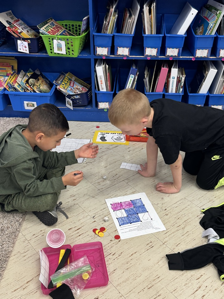 Two first grade boys playing a math game  