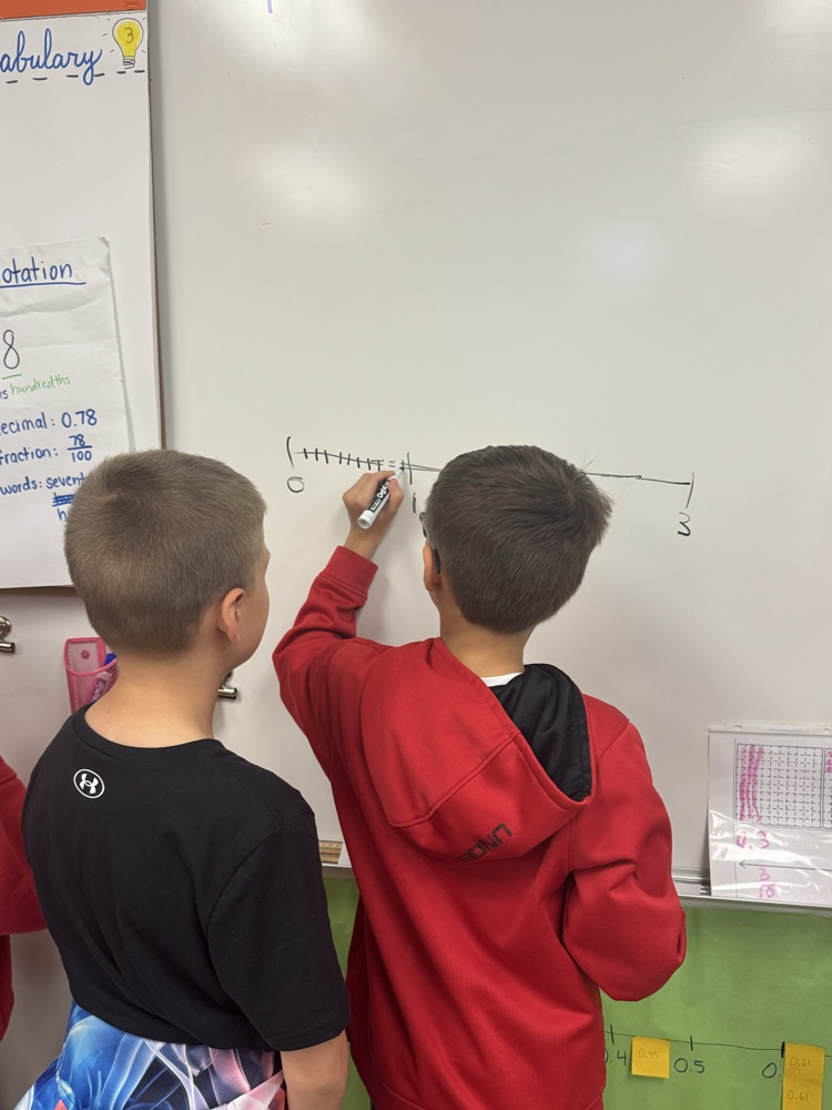 Two students working together to solve a math problem  