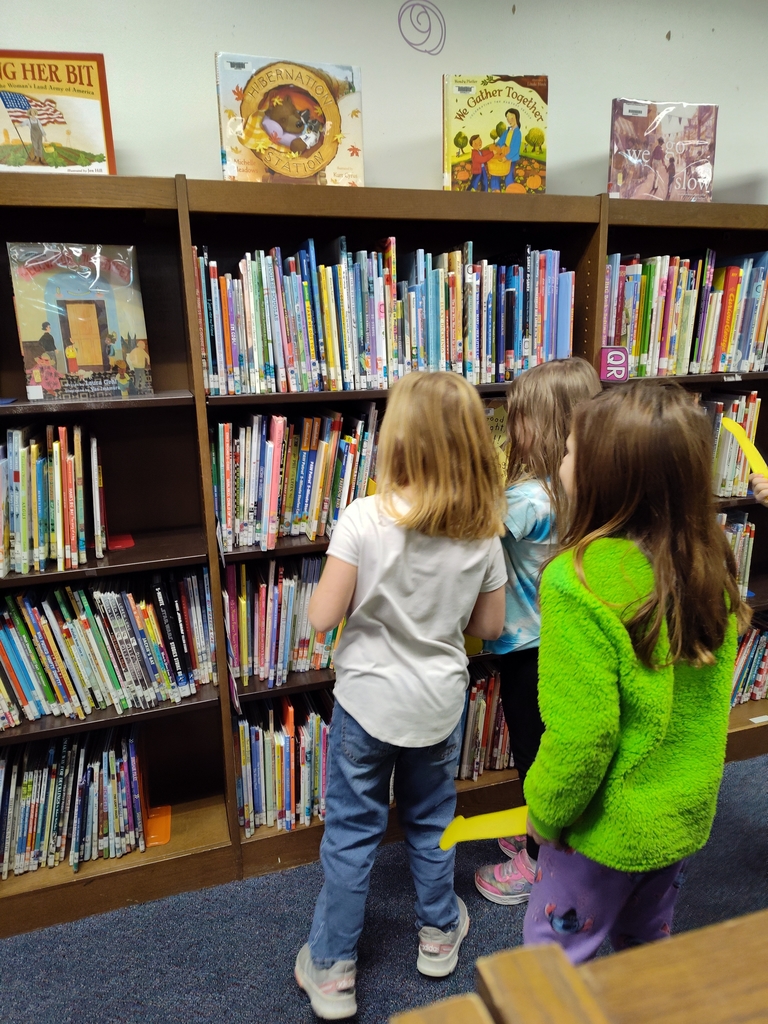 students crowd around a new arrival