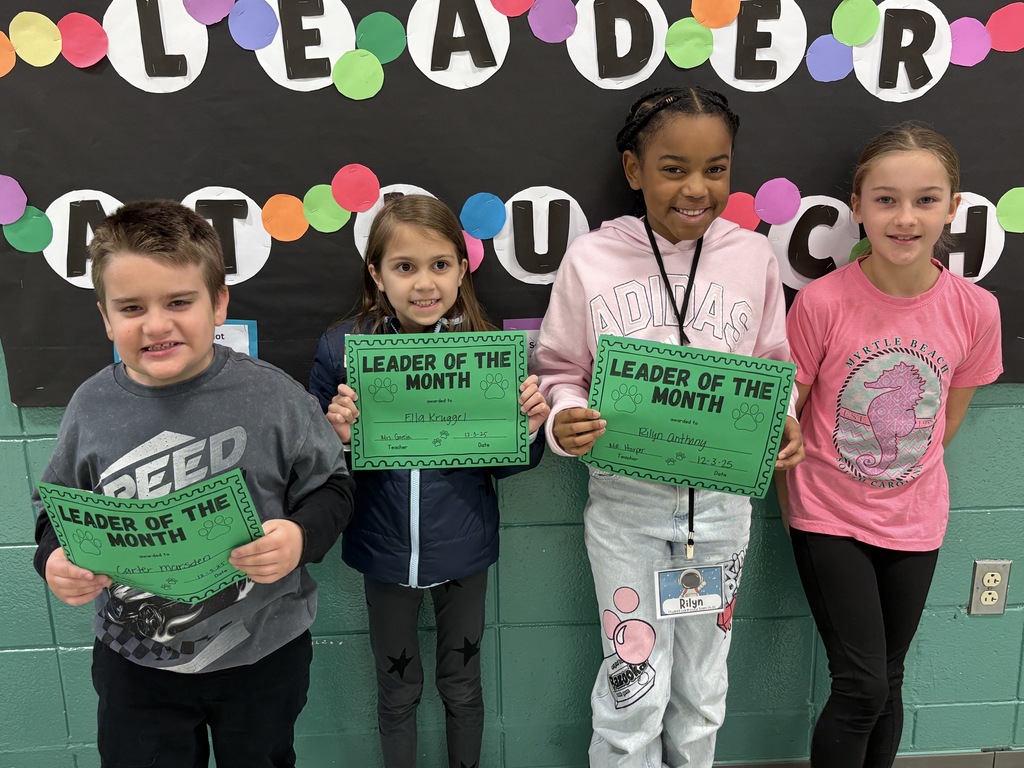3rd-grade students with their Leader of the Month Awards