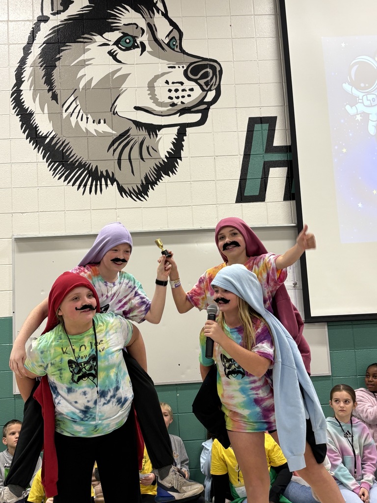 The Hairy Habit Huskies during their performance at Husky High Five Assembly