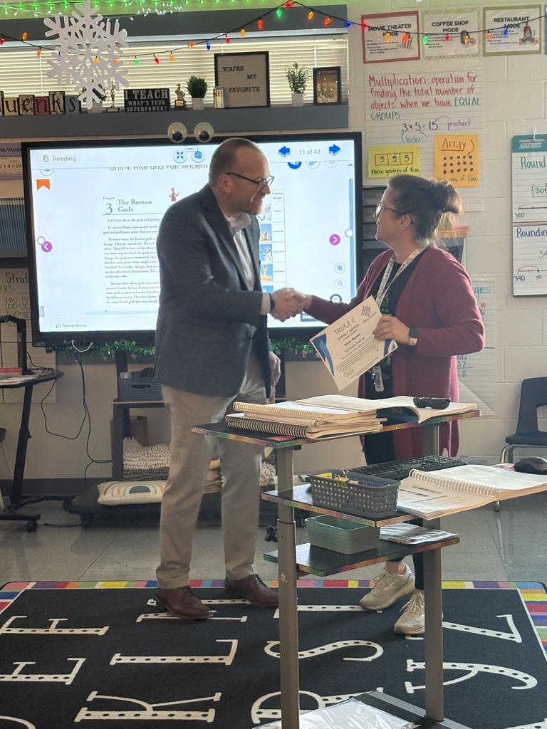 Mrs. Muenks receiving her Triple E Award from Henry St. Pierre