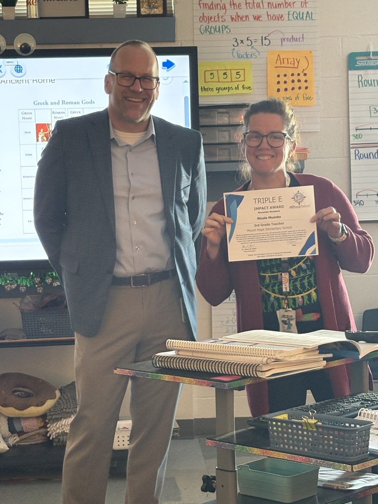 Mrs. Muenks receiving her Triple E Award from Henry St. Pierre