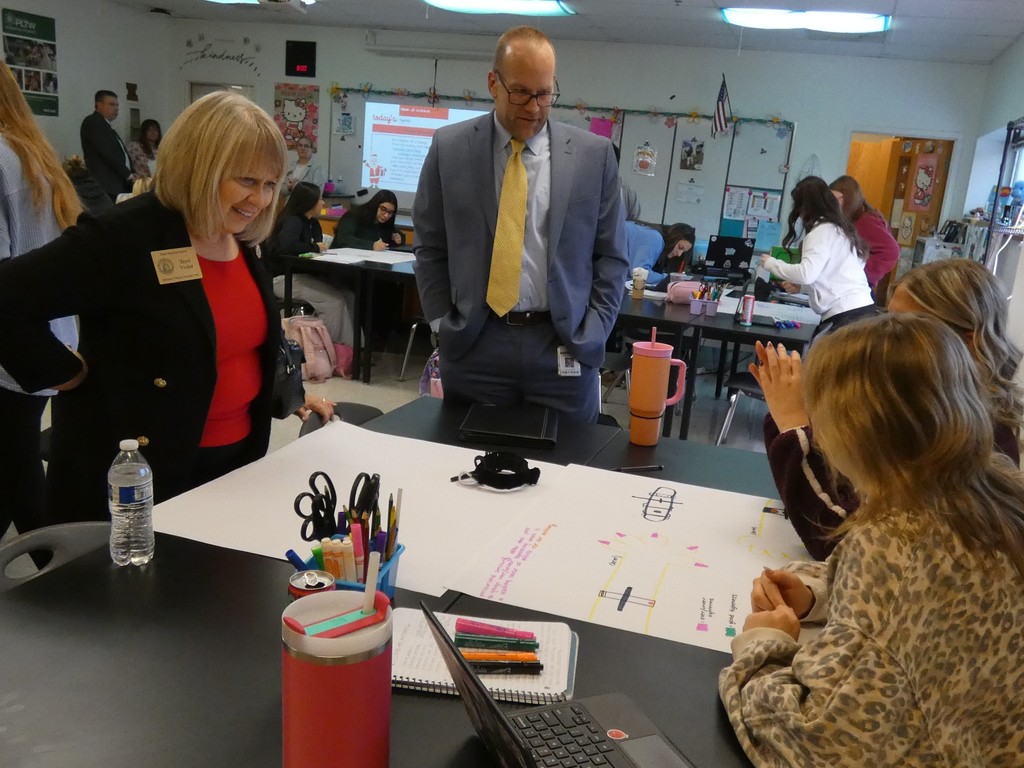 students describe their illustration for a proposed turniquette