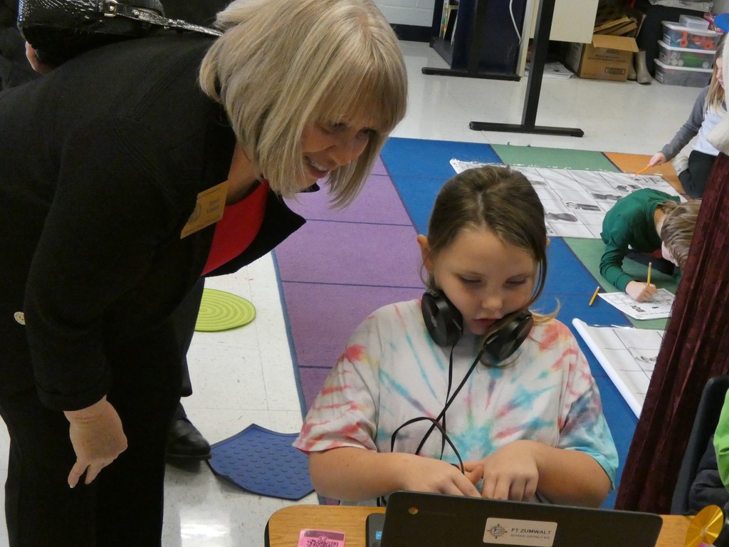 Second-grader offers legislator some tech tips.