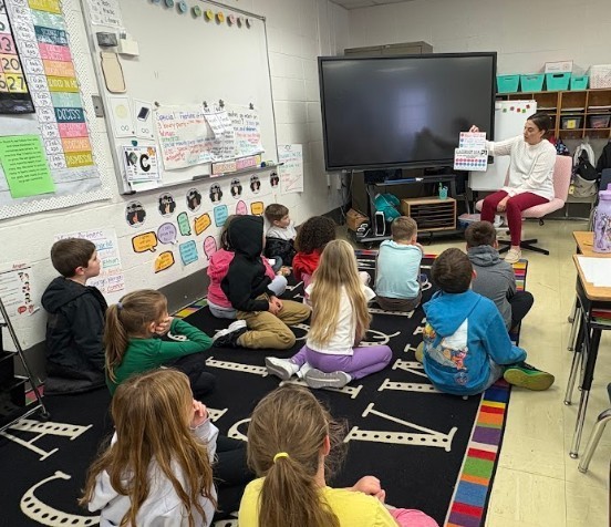 Mrs. Stephens showing her class their progres 