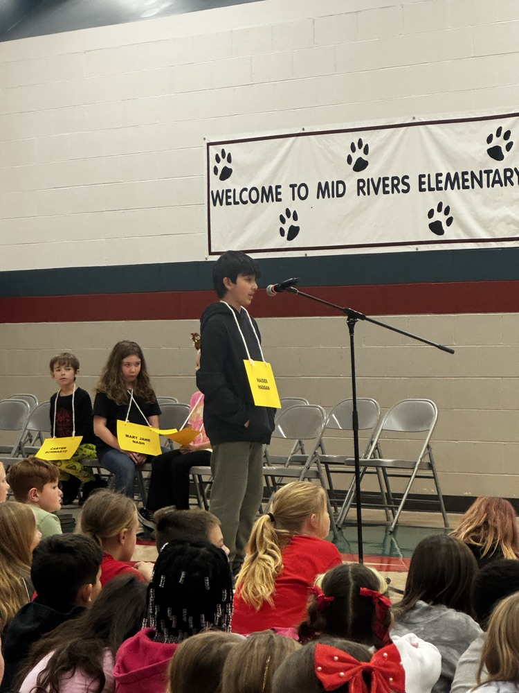 Haider standing at the mic spelling his word 