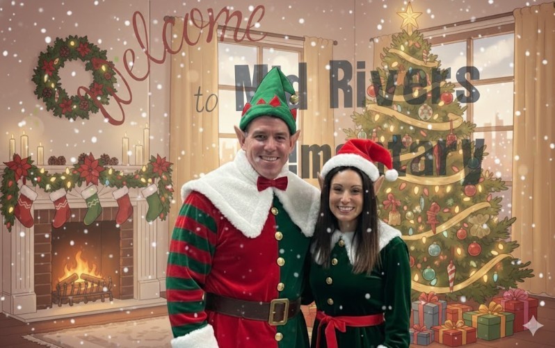 Mr. Musgrove and Dr. Romanchuk dressed up as elves standing in front of the tree!