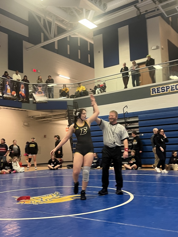 Shepard with her hand raised