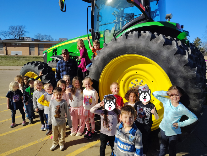 Kindergarten students get to take a look at Farmer Dyer's tractor