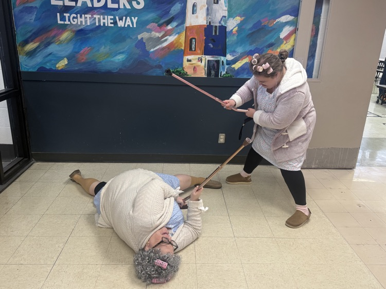 Staff members having a cane fight