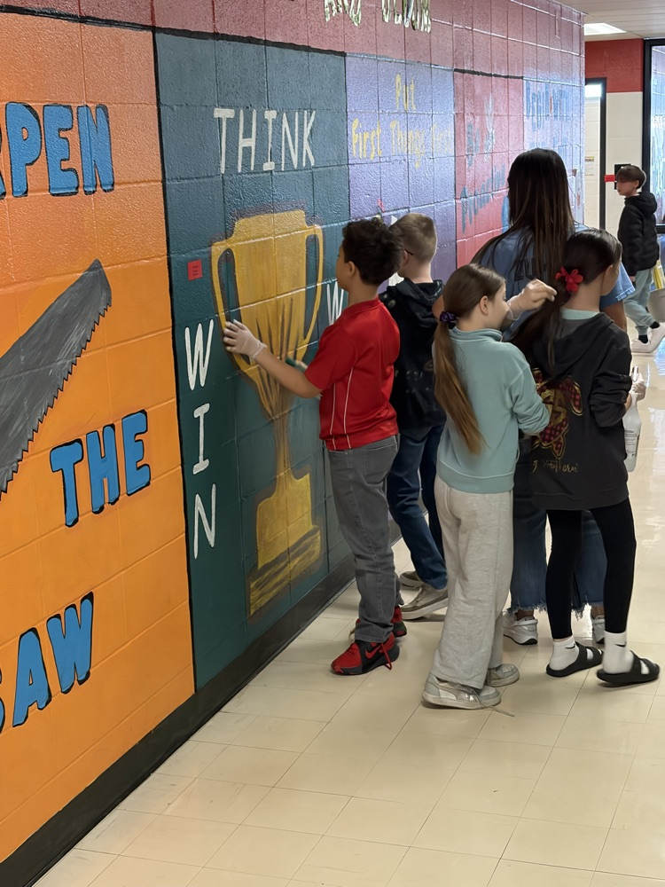 Students beautifying a mural 