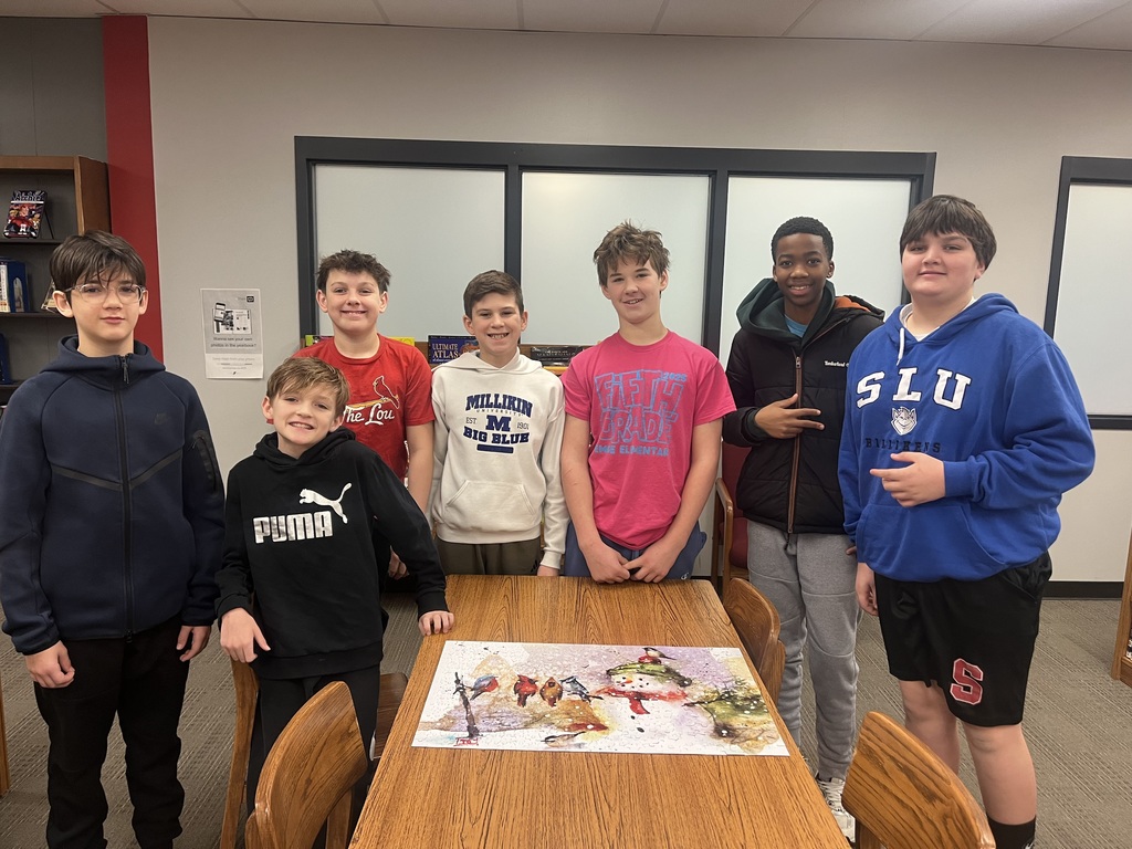 Students  posing with a completed puzzle