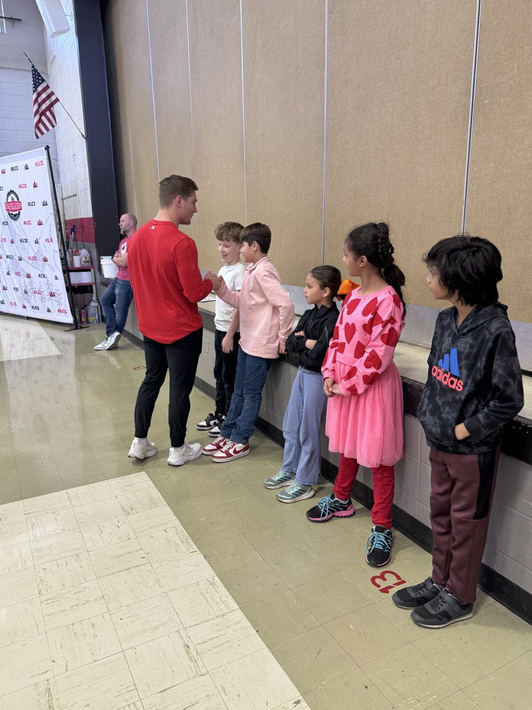 students standing, practicing their speeches