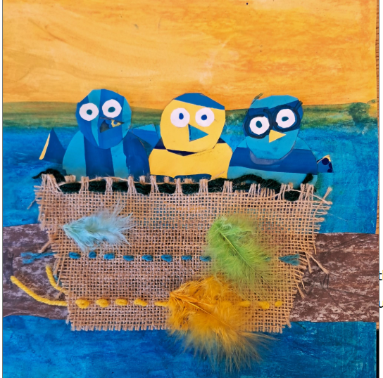 Blue and Yellow birds stare out of a burlap nest stitched with yarn and a pop of blue and green feathers