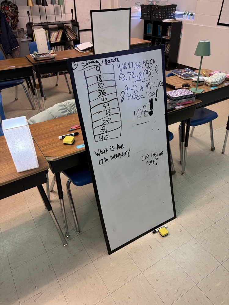 a large whiteboard with math written upon it in black marker ink