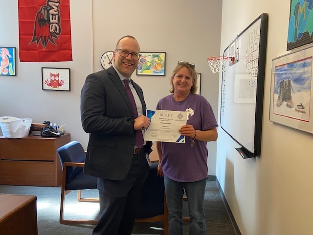 picture of Melissa Clarke and Dr. St. Pierres presenting her an award