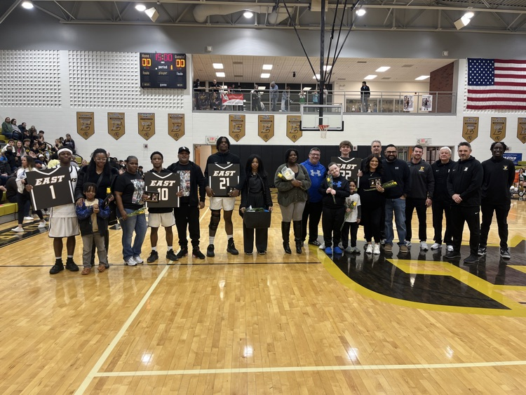boys basketball seniors and their families on the court