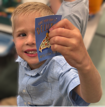 Student holds out note for adult to read with them