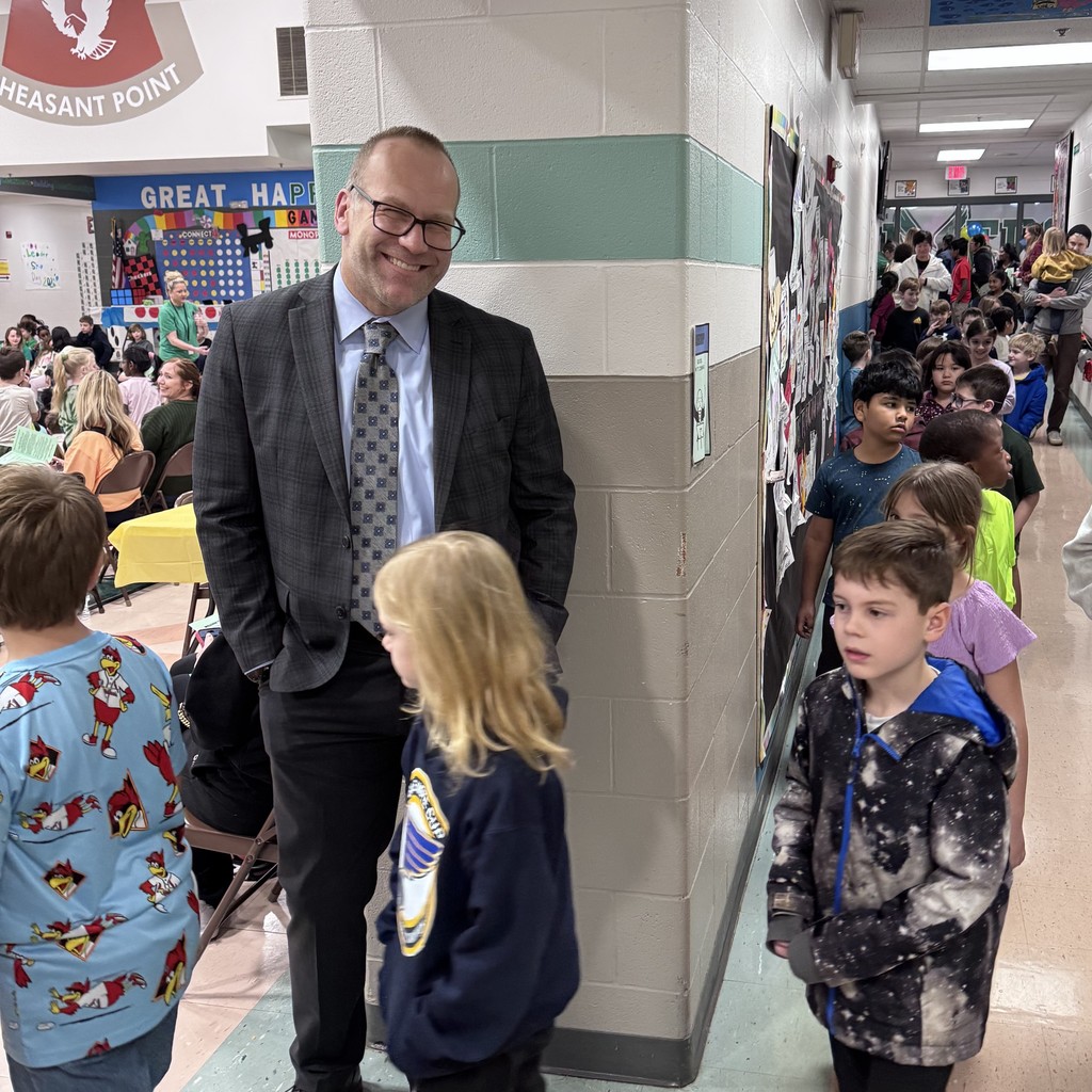 students file past superintendent on way to assembly