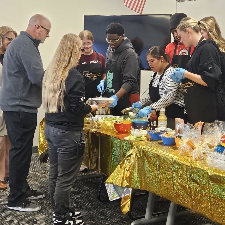 Students serve principals in buffet line