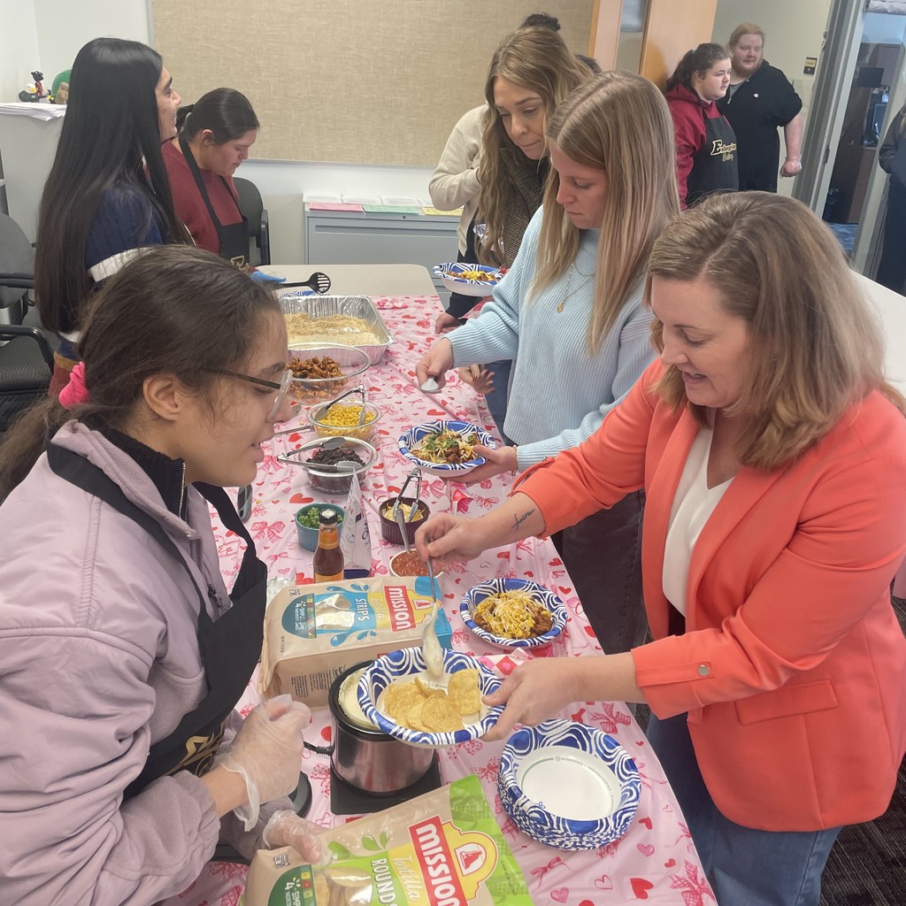 Students serve staff in the buffet line