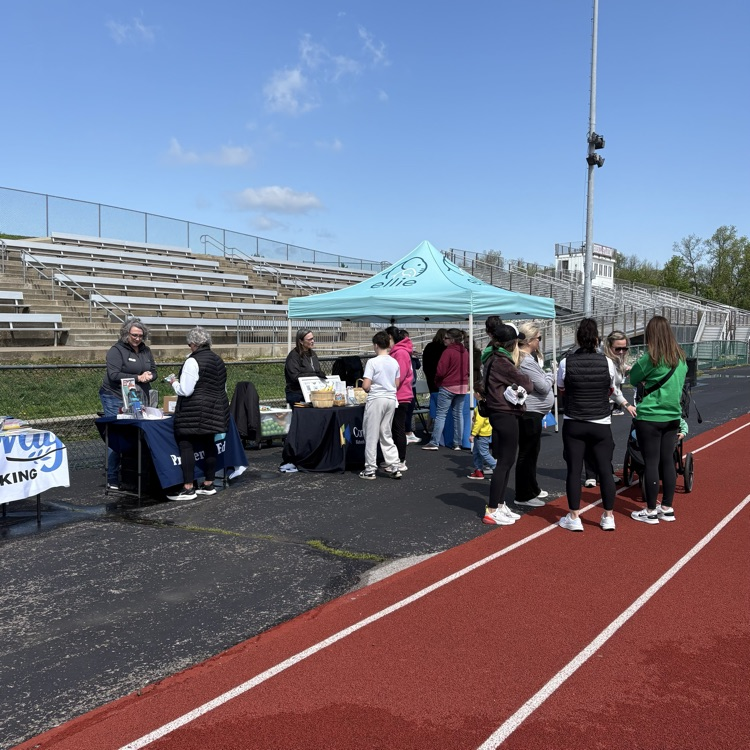 groups gather under tailgate tents gathering pamphlets, etc
