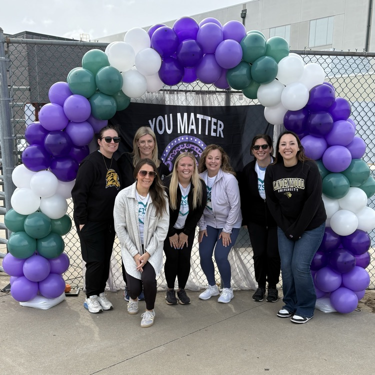 FZ mental health professionals pose under balloon arch