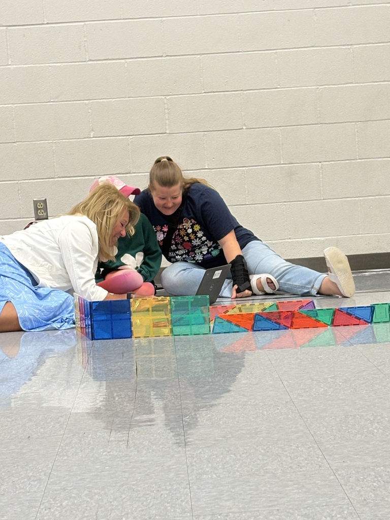 A family working on their code to get their Sphero robot through the maze