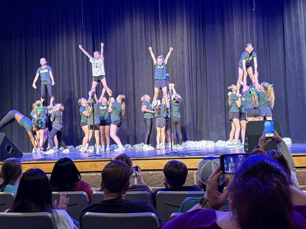 4th and 5th grade Huskettes doing cheer stunts