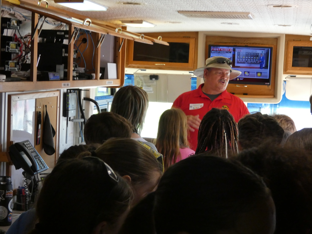 Students pile inside the police department's mobile command center