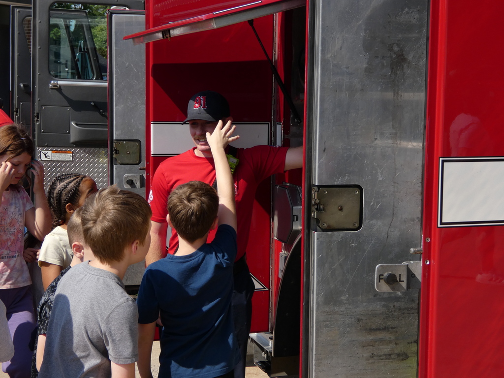Students swarm fire truck to see gear inside