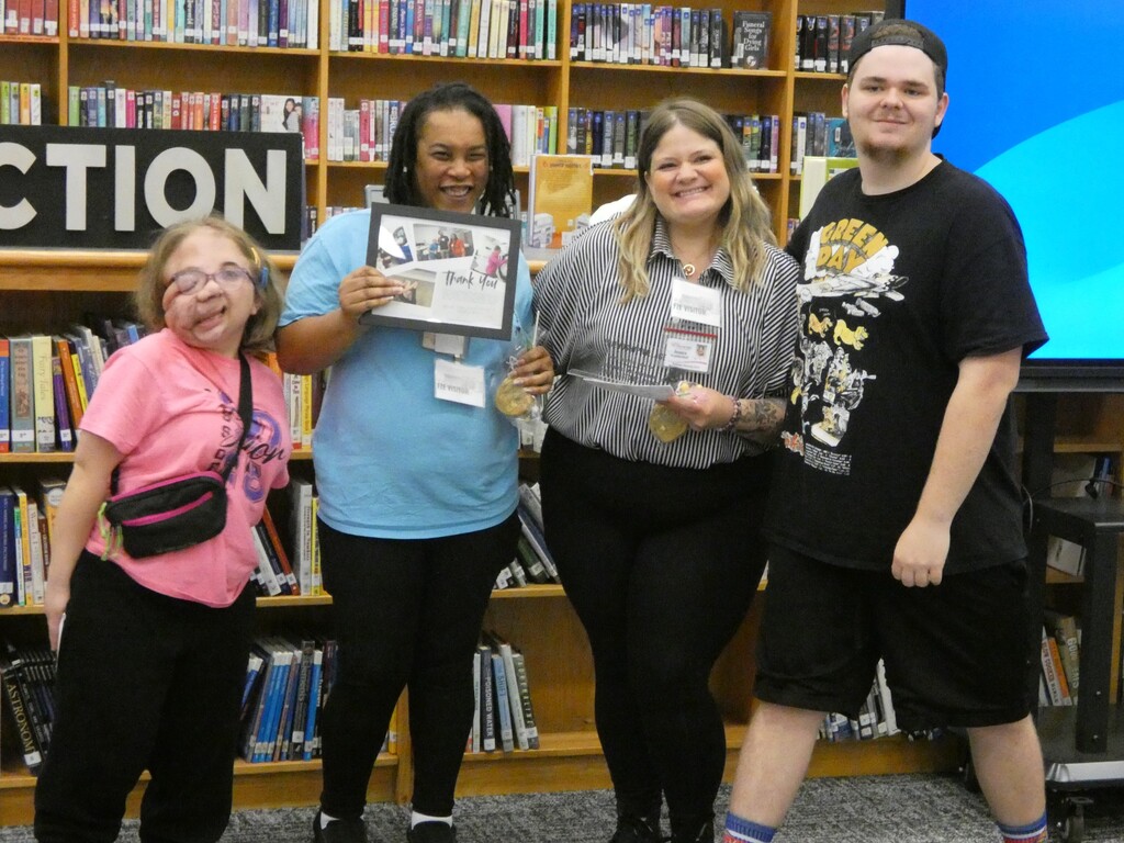 Students pose with business partner