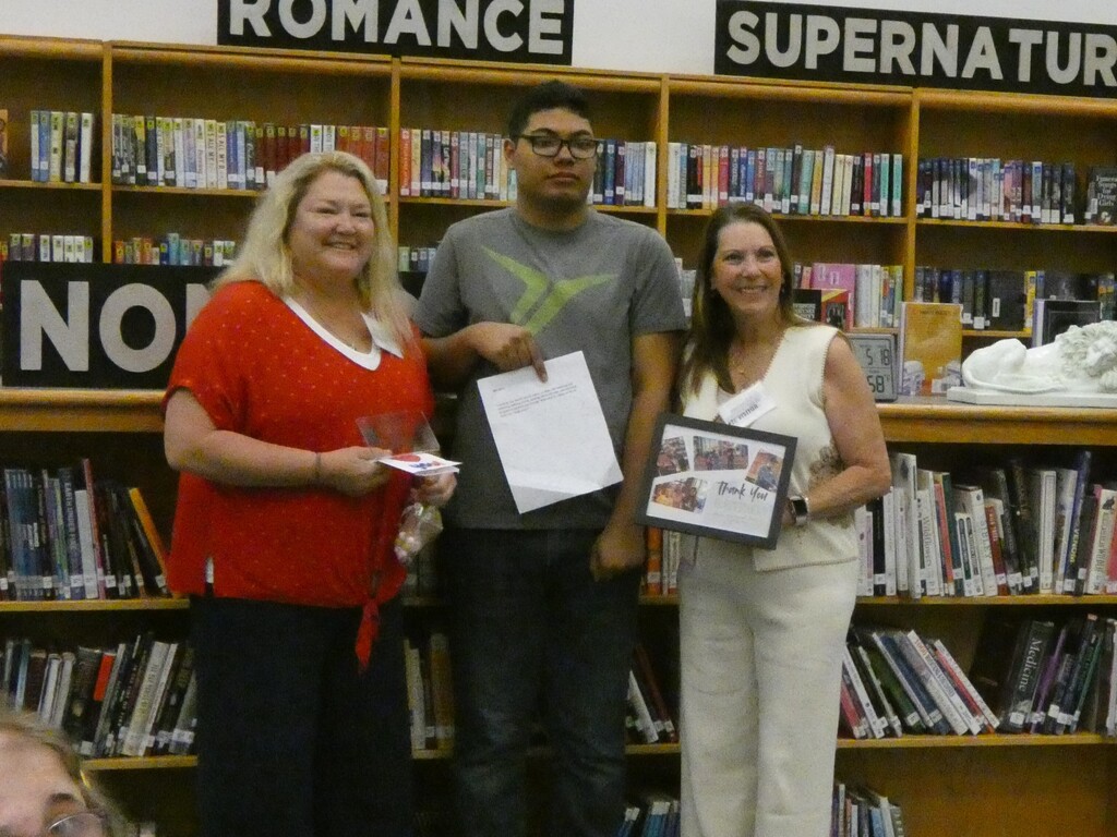 Students pose with business partner
