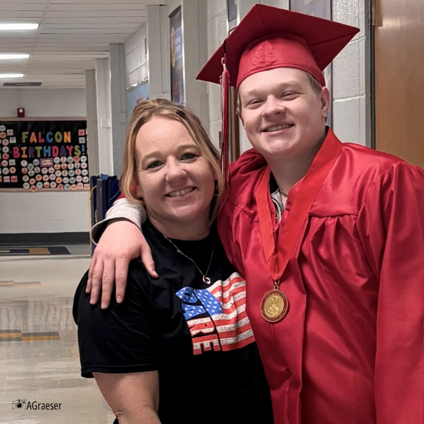 grad in cap and gown with teacher