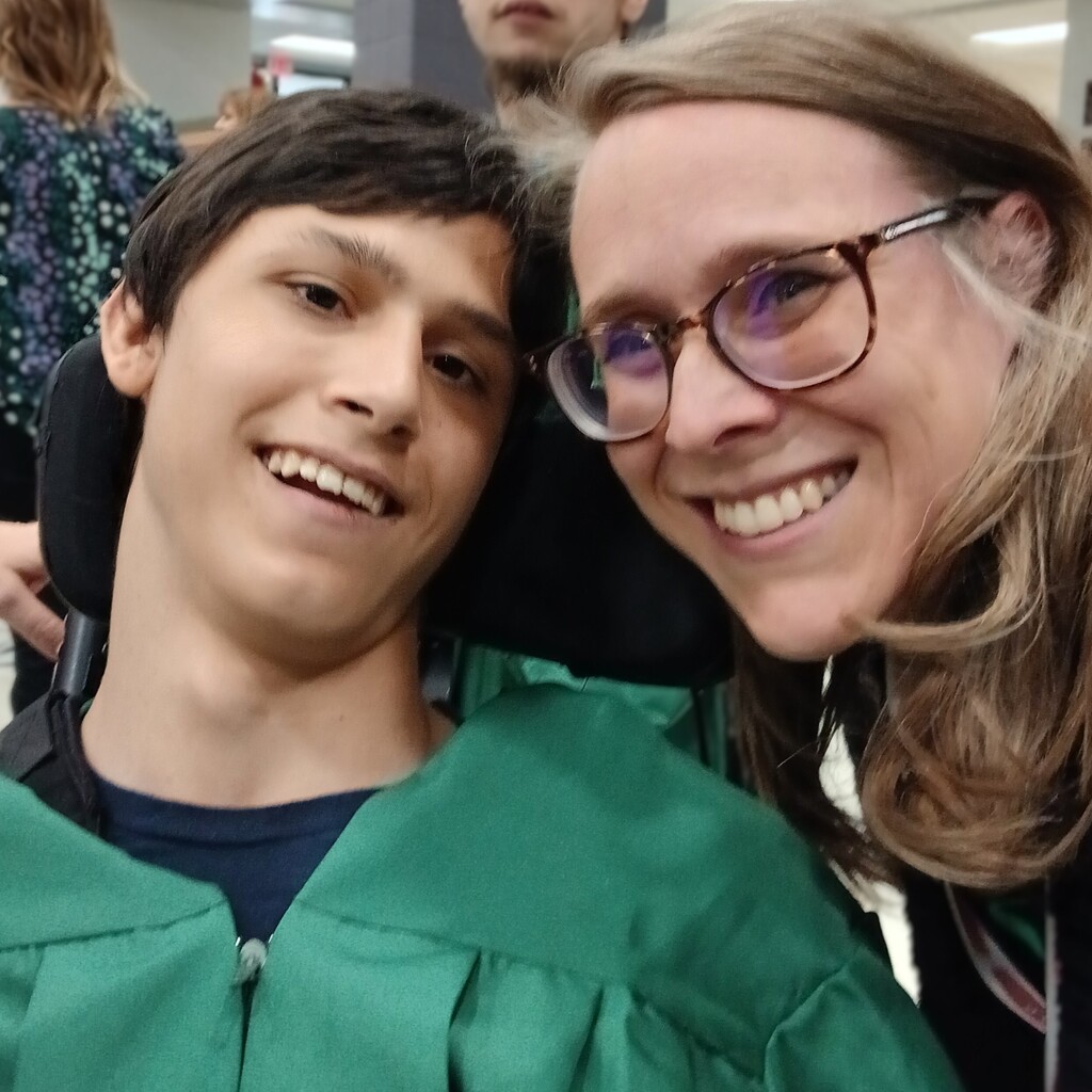 former teacher poses with grad in cap and gown