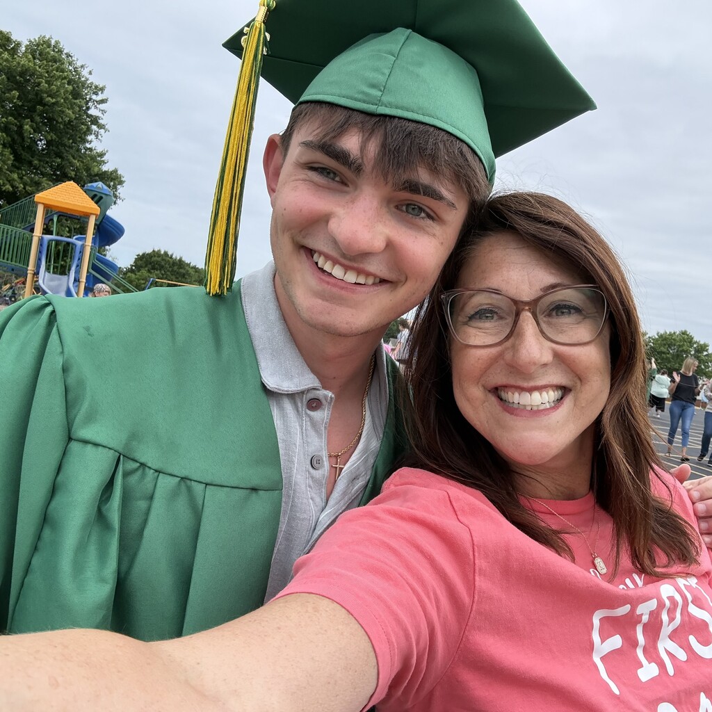 former teacher takes selfie with grad in cap and gown