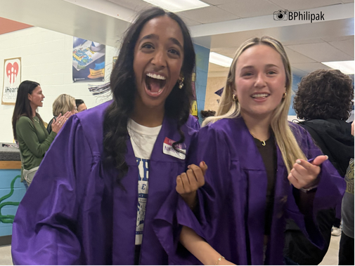 students in caps and gowns recognize former teacher with surprise