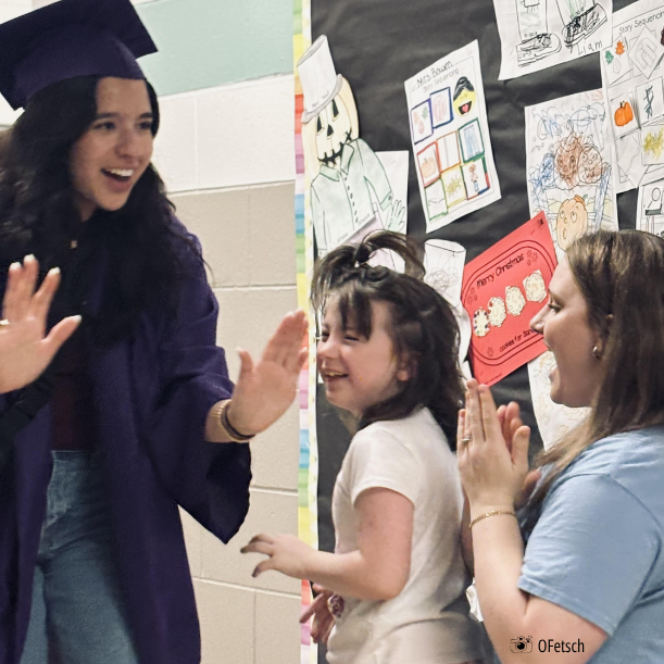 elementary student beams at smiling waving grad