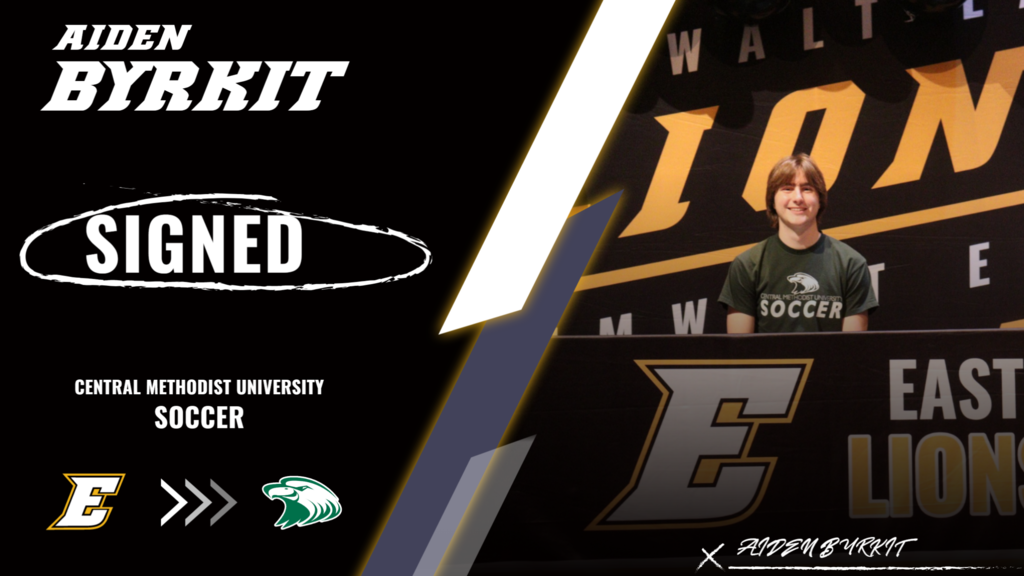 Aiden Byrkit sitting at the signing table.