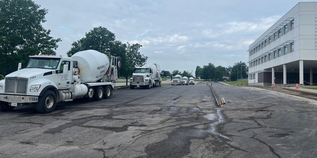concrete trucks line one side of parking lot
