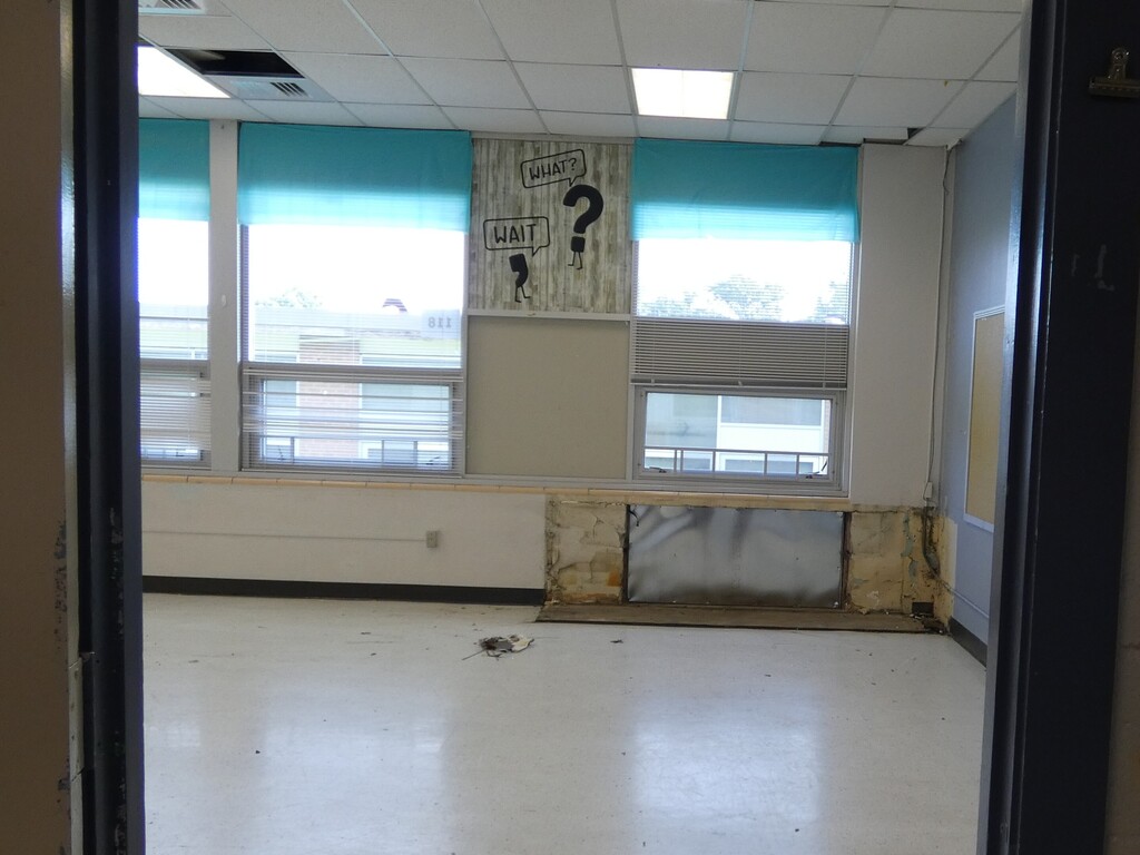 view through classroom doorway to space where unit ventilator has been removed