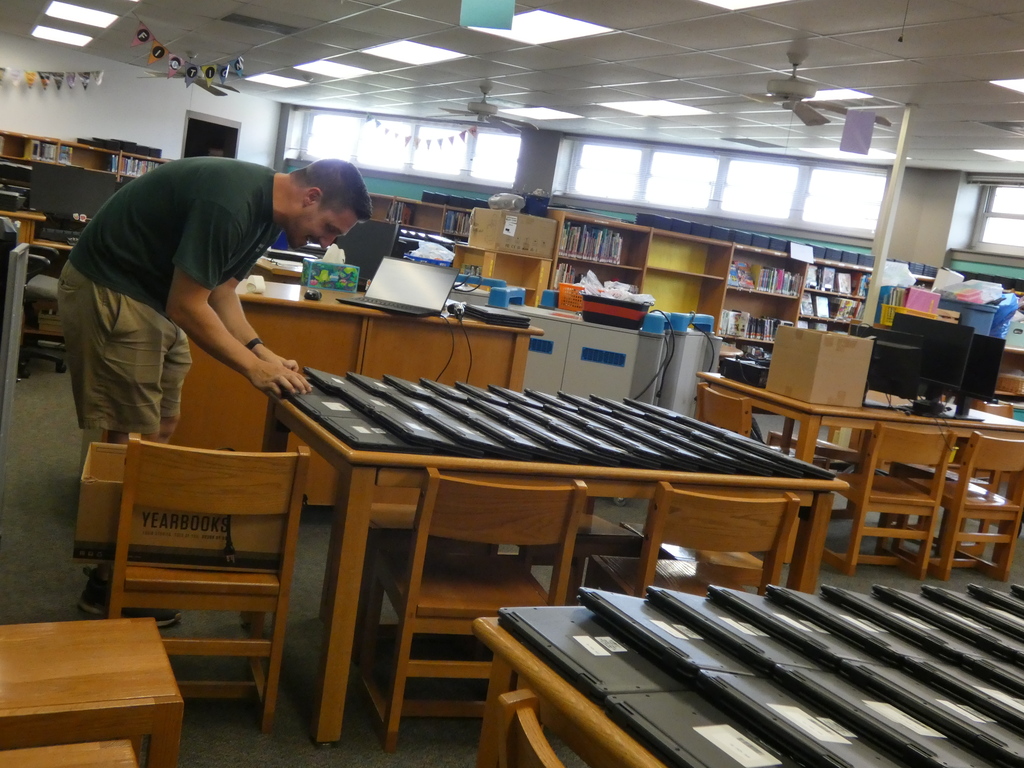 Computer techs scrub and repair Chrome Books for next school year