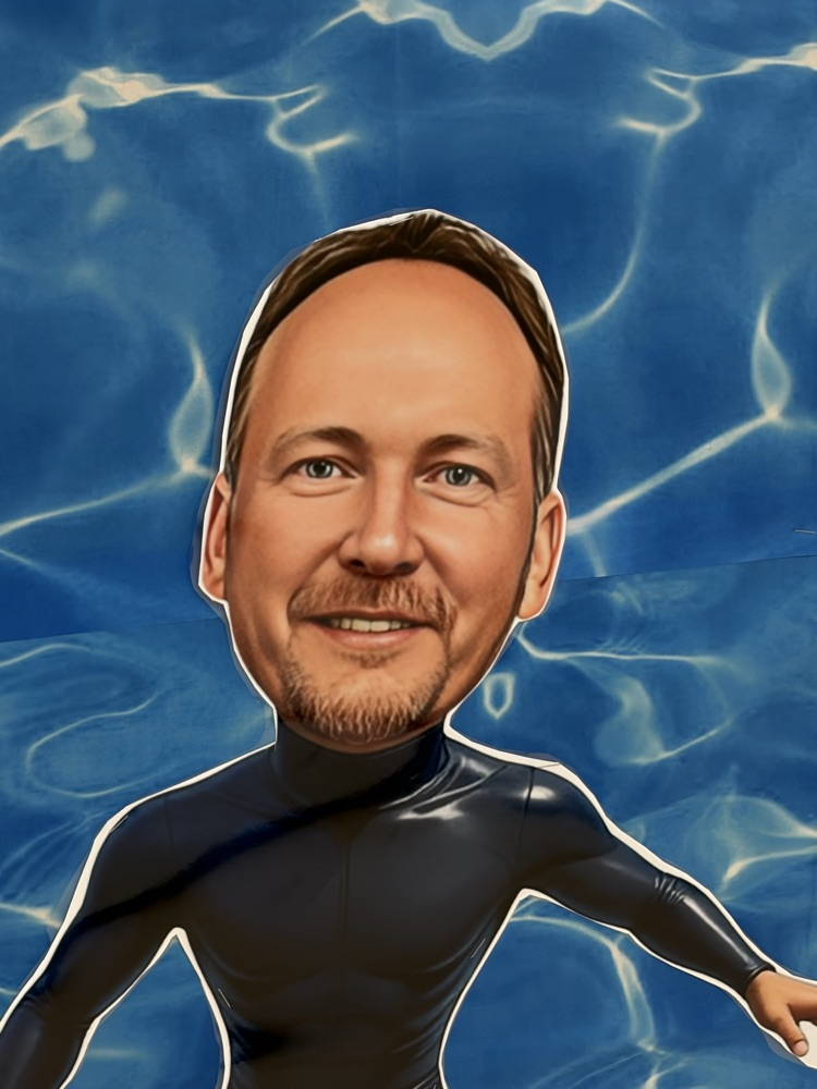 Dr Kraft dressed as a surfer in a black wet suit 
