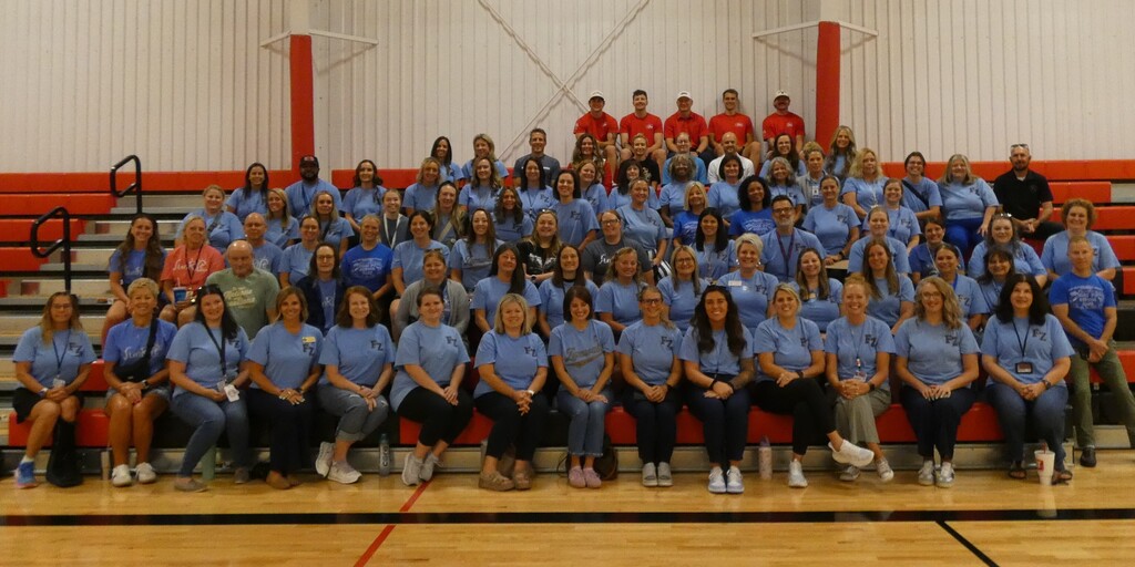 group shot of volunteers on bleachers